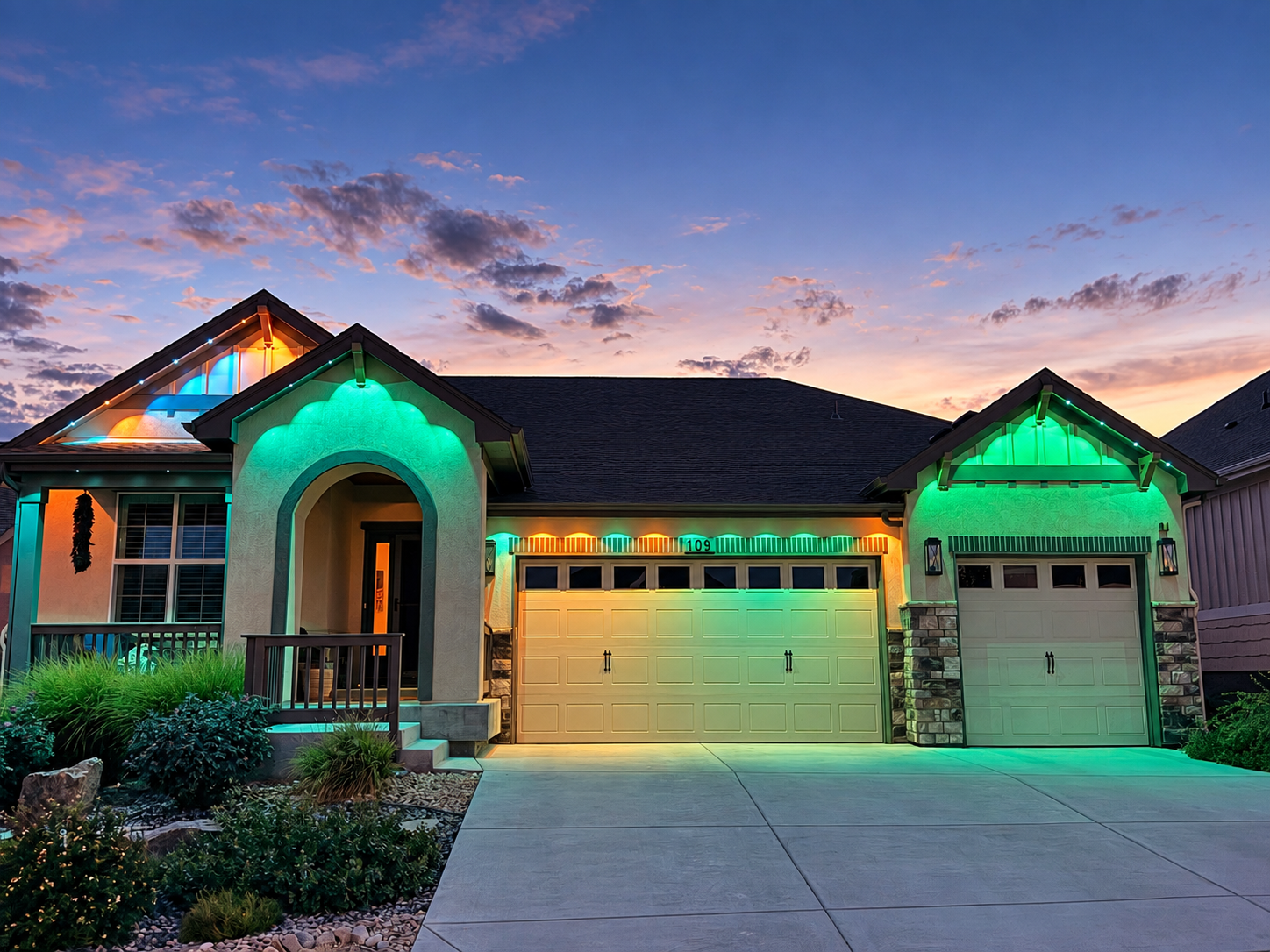 A home roofline lit at dusk with lights installed in PopTrack